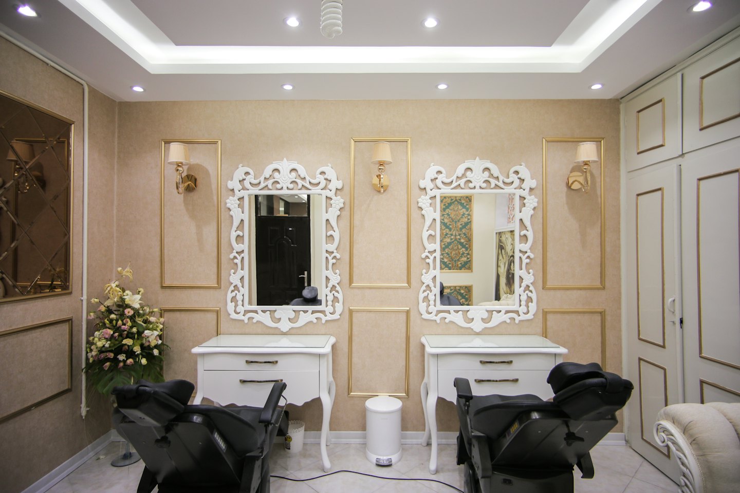 Ornate mirrors and vanities in a luxurious salon.
